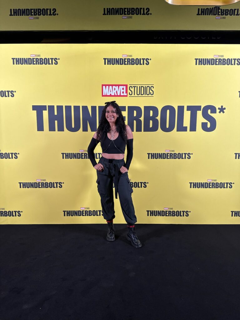 Dani at the thunderbolts premier in front of the thunderbolts promotional backdrop